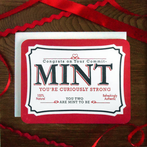 rectangular letterpress heavy cardstock greeting card designed in the style of an Altoids container in black, red, and white with the message "Congrats on Your Commit-MINT" "You're curiously strong" "100% Natural Refreshingly Authentic" "You Two Are Mint To Be"