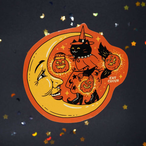 die-cut vinyl sticker of a large yellow crescent moon with smiling face and black cat in retro witch costume holding three jack-o'-lanterns