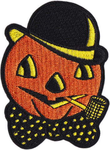 patch of a vintage style Halloween decoration, featuring a pumpkin head with a bowler hat, bow tie & corncob pipe