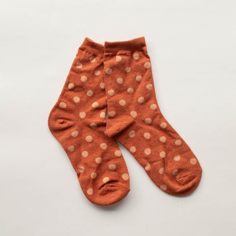 cotton knit socks in a heathered rusty orange with an allover light orange polka dot knit-in pattern