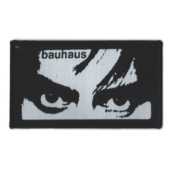 rectangular embroidered patch featuring image of Peter Murphy's eyes up close with Bauhaus typography in grey on black background