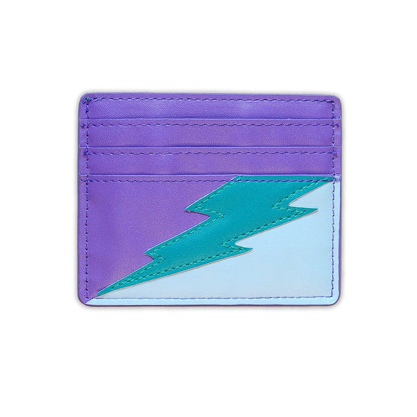 rectangular faux leather 6 slot card holder in bright purple and light blue with diagonal teal faux leather lightning bolt applique in middle. Shown from front