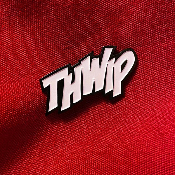 comic sfx onomatopoeia enamel pin "THWIP" in white on red background