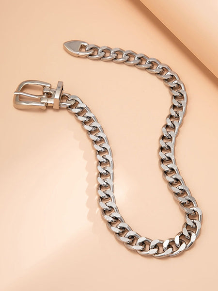 Silver metal curb style chain choker with belt style buckle and tail closure. Shown flat and open