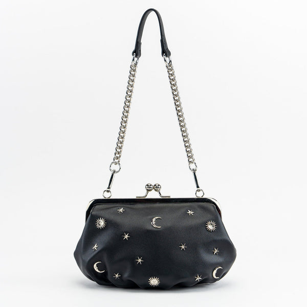 black textured faux leather purse with silver metal kiss lock and silver metal stars, crescent moons, and sun embellishments. Attached is an 11" chain link and faux leather shoulder strap. Shown from front