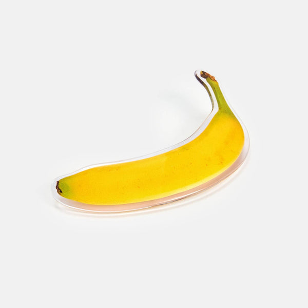 large acetate pinch clip style acetate barrette in a photorealistic yellow ripe banana design. Shown flat
