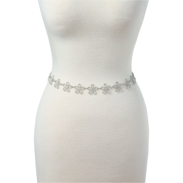 silver metal chain belt with linked row of stylized silver metal daisies. Shown on dress form