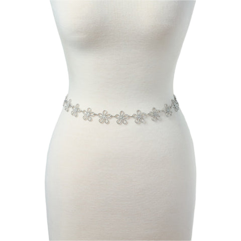 silver metal chain belt with linked row of stylized silver metal daisies. Shown on dress form