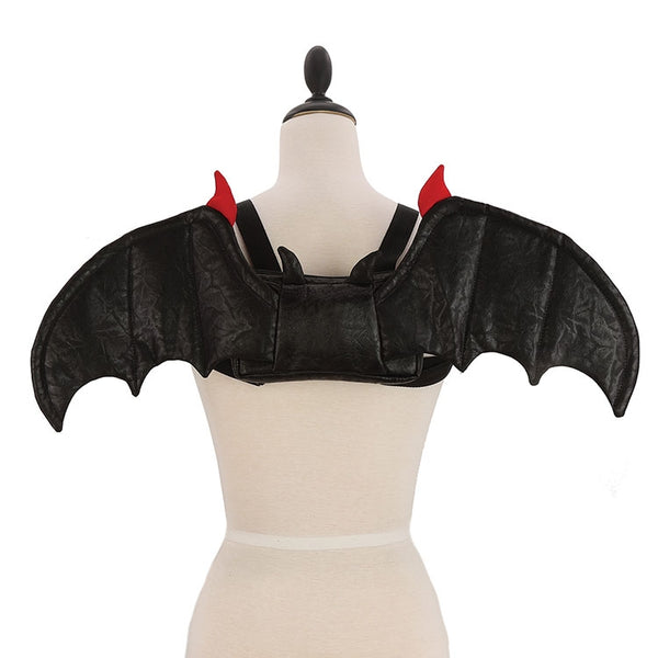 Novelty mini backpack in soft velvety black fabric with attached 24” wide batwing appliqué in matching fabric with red tips. Body of backpack is in matching fabric with pointy bat ears. Shown on dress form 
