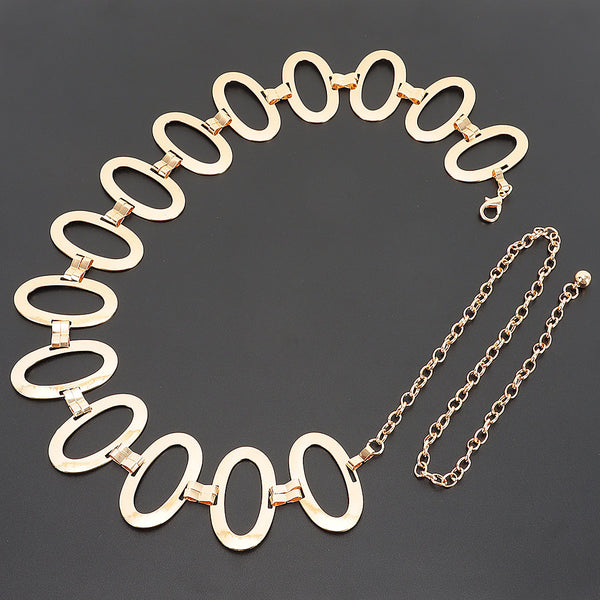 A gold metal chain belt with large flat oval links and a dangling chain extender, shown flat