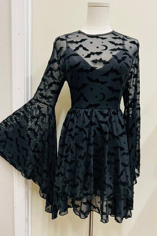black mesh fit and flare mini dress with an all-over black flocked flying bat and moon & star pattern. The dress has a jewel neckline, extreme bell sleeves, a double tiered ruffled skirt, and a v-neckline lining. Shown from the front on a dress form with sleeve pulled taut to show shape