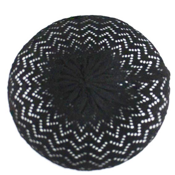 black openwork knit beret with a chevron pattern