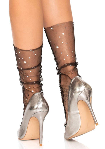 Model wearing black mesh crew socks with silver moon, star, and round silver confetti embellishments. Shown from back