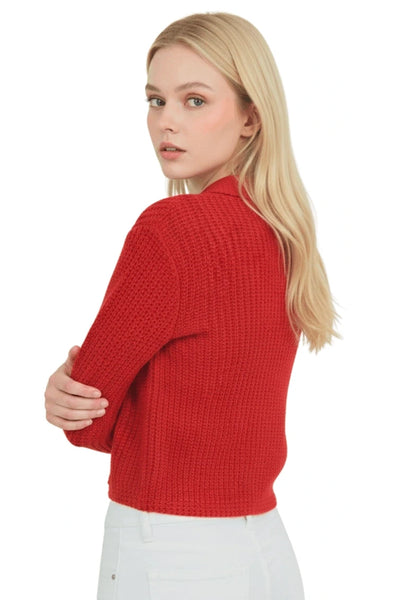 back view of model wearing red chunky rib knit collared cardigan