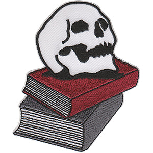 embroidered patch depicting a skull resting on a pile of books