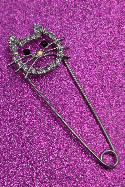 silver metal safety pin with pin closure in the shape of a cat head with clear "rhinestone" jewels & black jewels for eyes