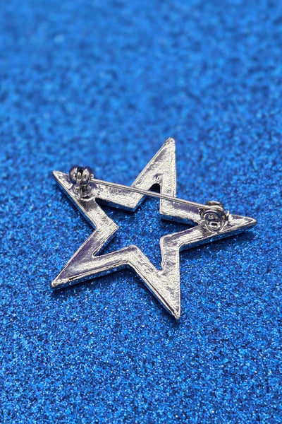 shiny silver metal star-shaped brooch inlaid with sparkly clear rhinestone style jewels, showing back view with pin clasp fastener