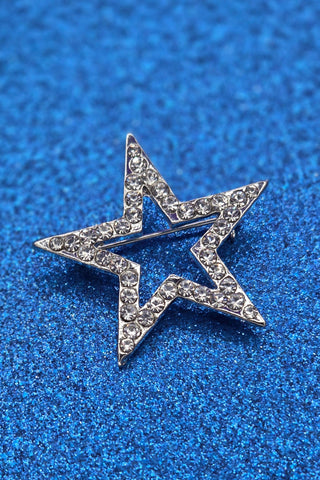 shiny silver metal star-shaped brooch inlaid with sparkly clear rhinestone style jewels