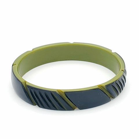 black and olive green resin bangle in a  carved diagonal “cinched” stripe motif