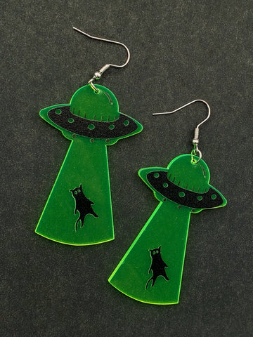 laser cut translucent neon green acrylic dangle earrings with printed detail of a black UFO pulling a black cat towards it with a tractor beam