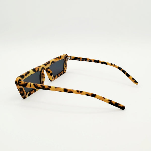 80s style narrow flat bridge photorealistic leopard print plastic frame sunglasses with dark smoke lens, showing reverse in 3/4 view