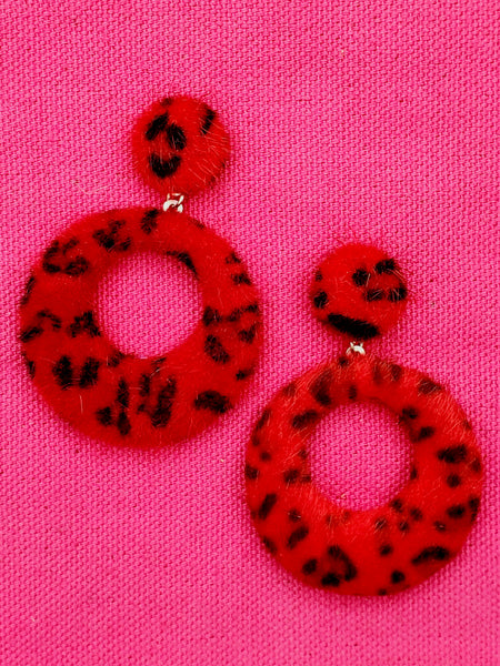 Drop hoop earrings attaching to ear as post in red leopard printed faux pony 