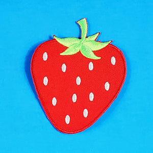 An embroidered patch of a large strawberry, in bright red with a green stem and white seeds