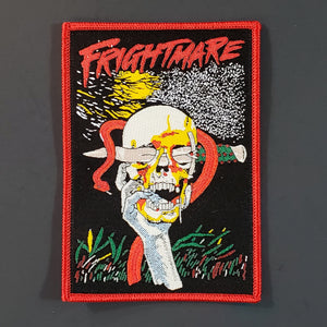 Rectangular red, yellow, green, grey, and black woven patch with illustration from the movie Frightmare depicting a hand holding a skull with a large blade stuck through the eye socket with a red snake coiled around it
