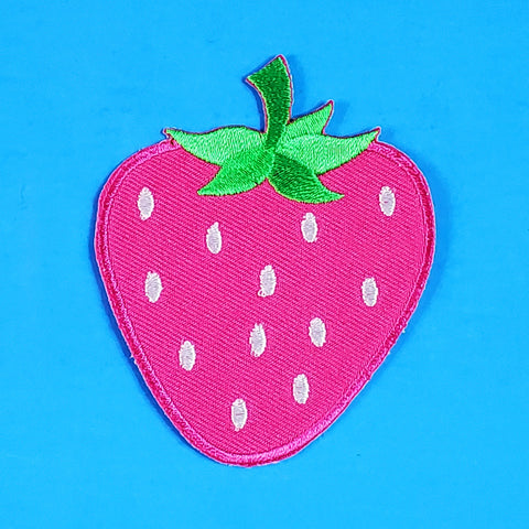 An embroidered patch of a large strawberry, in rich pink with a green stem and white seeds