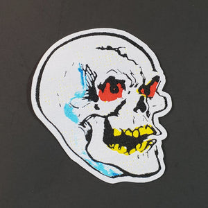 Woven light grey, blue, red, yellow, and black patch of a skull