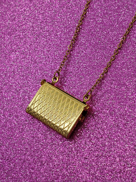 shaped crosshatch patterned locket necklace on link chain, showing view of the back