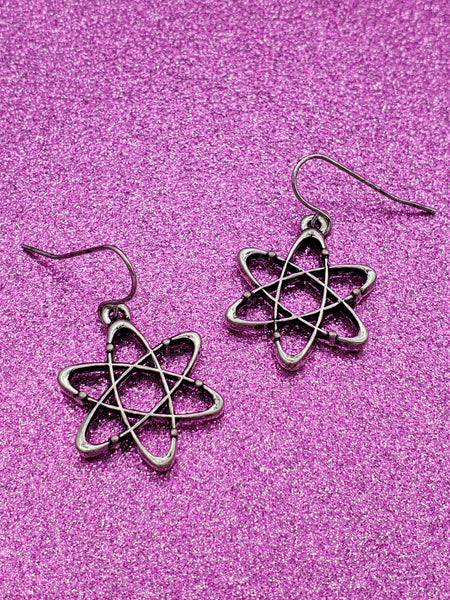 silver metal dangle earrings with atom shaped charms.