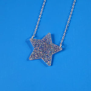 sparkly silver glitter star shaped acrylic resin pendant attached to a silver plated curb style chain