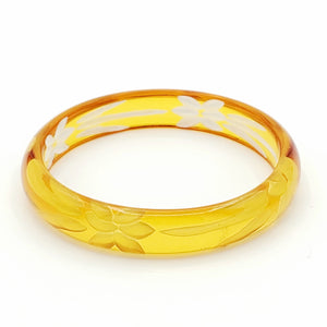 translucent rich mandarin orange resin bangle with reverse carved floral motif interior