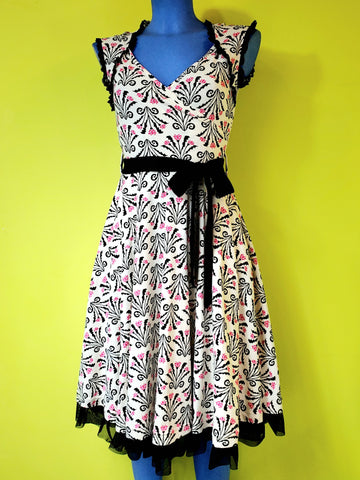 stretch cotton knit sleeveless fit & flare dress in a cream background black & pink damask style floral pattern 