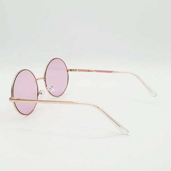 2 1/4” round sunglasses with thin gold metal frames and colorful pale pink tinted lenses, showing reverse in 3/4 view