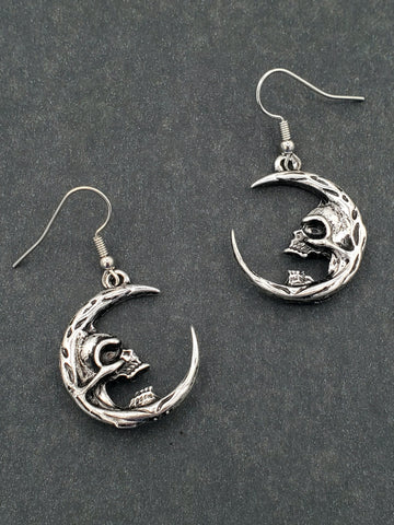 pair of silver metal crescent moon with skull "face" dangle earrings