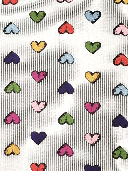 Warm light beige background with delicate vertical stripe pattern and all over staggered cartoony red, yellow, light blue, royal blue, purple, and pink heart pattern