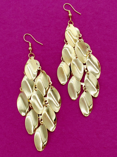 gold metal dangle earrings of stylized leaf shapes staggered together with jump rings