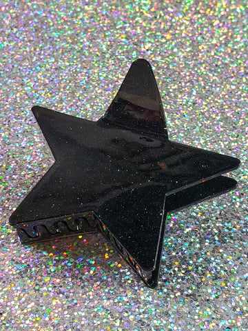 3 1/2” claw style black acrylic with silver glitter hair clip in the shape of a pointy star