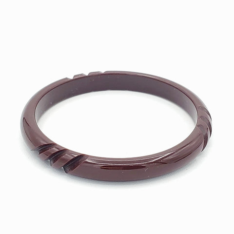 dark reddish brown resin bangle with carved diagonal stripe details