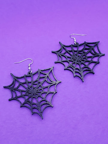 pair of glitter black laser-cut acrylic triangular spiderweb dangle earrings