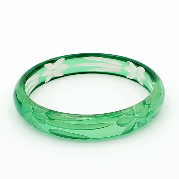 translucent cool green resin bangle with reverse carved floral motif interior