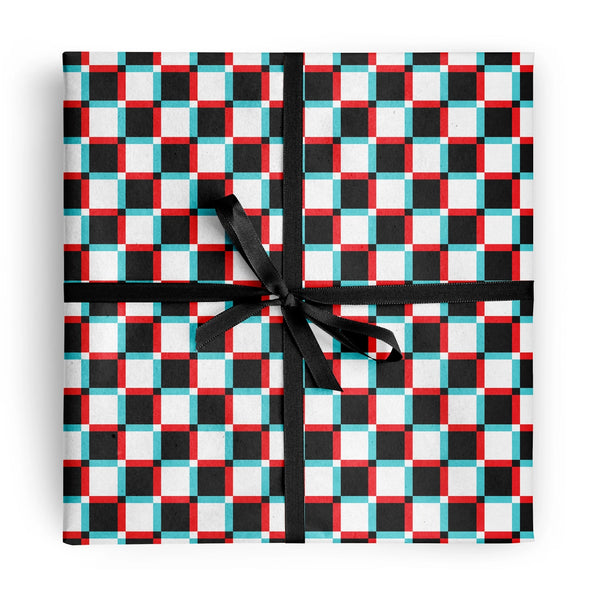 square package wrapped in heavyweight matte wrapping paper in a white background black, cyan, and red anaglyph 3D checker pattern, and finished with black ribbon bow