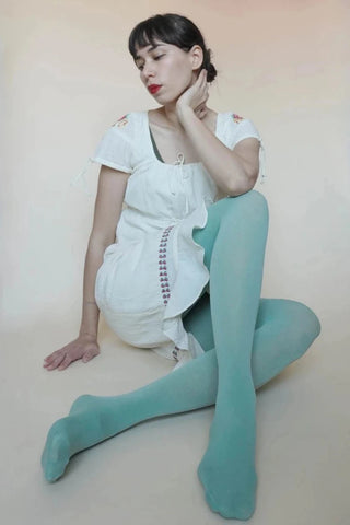 80 denier matte finish "Zokki" opaque tights in a dusty mint color, worn by a model