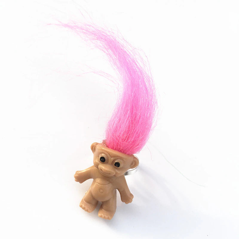mini troll doll with neon pink hair on an adjustable silver metal ring