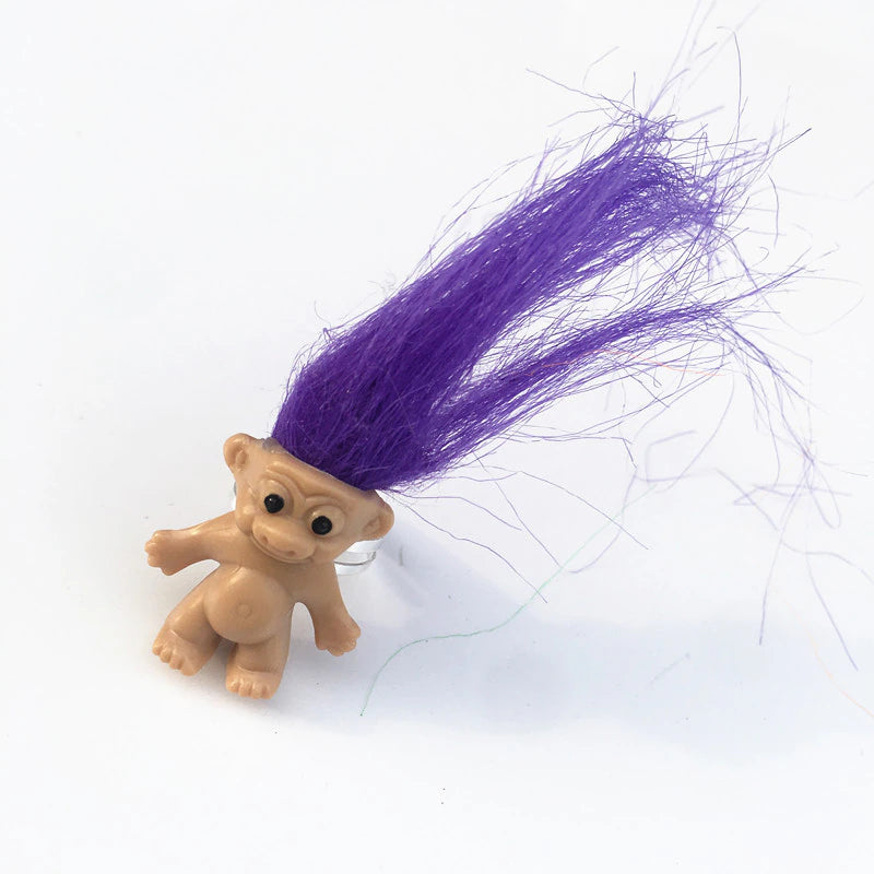 mini troll doll with neon purple hair on an adjustable silver metal ring