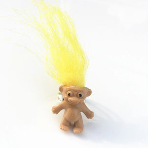 mini troll doll with neon yellow hair on an adjustable silver metal ring