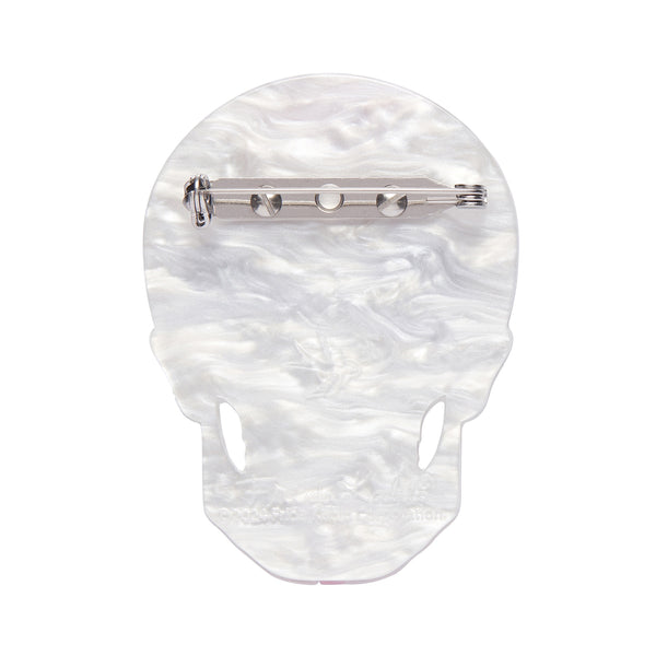 Frida Kahlo Collection “Dia De Los Muertos” layered resin calavera brooch, showing white backing layer with silver metal pin clasp
