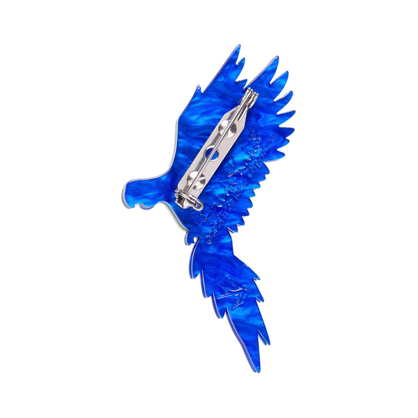 Frida Kahlo Collection “Frida's Parrot” blue and yellow bird in flight layered resin brooch, showing blue backing layer with silver metal pin clasp